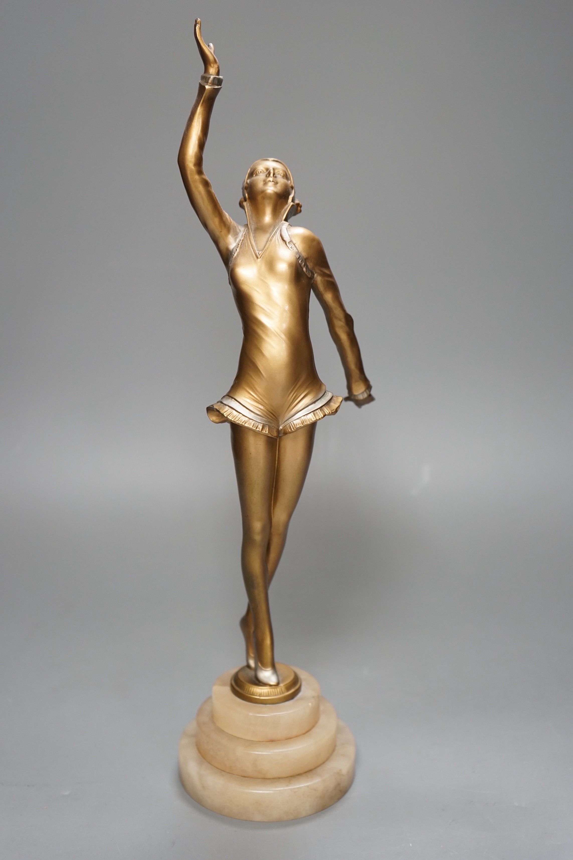 An Art Deco gilt metal model of a dancer, on stepped alabaster base, 41cm